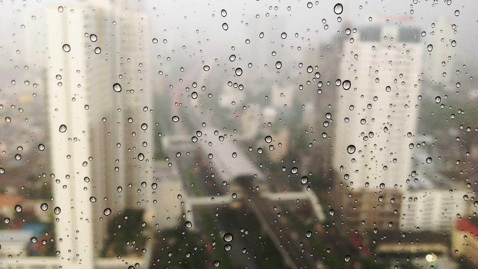 City lights seen through a rain-covered window